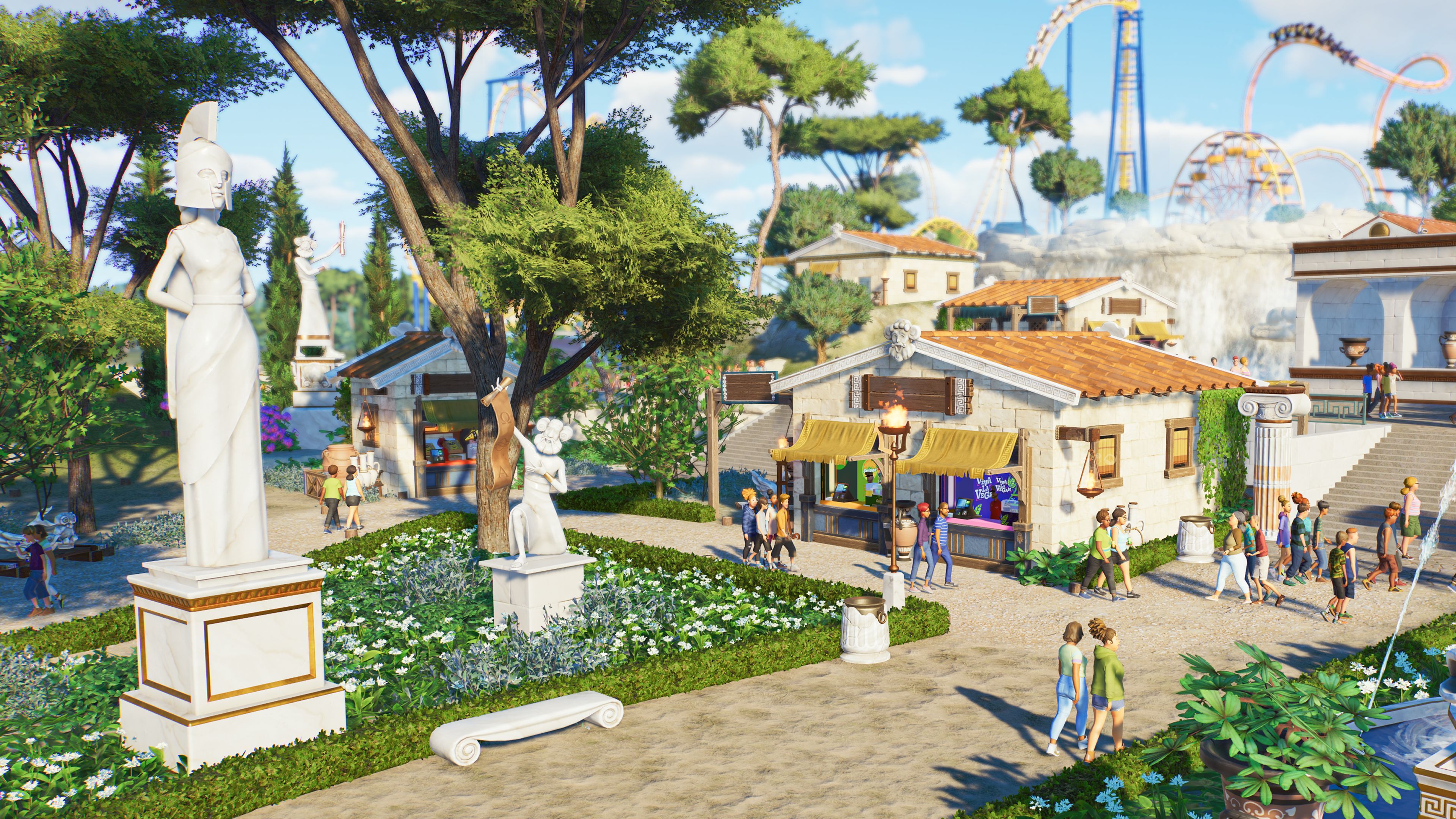 Planet Coaster 2 Mythology Conjunto de peças como estátuas gregas e pilares colocados no parque ao redor das barracas de comida enquanto os participantes passam.