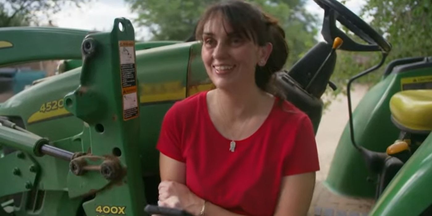 Rayne Hernandez in 90 Day Fiancé in red shirt smiling sitting on a tractor