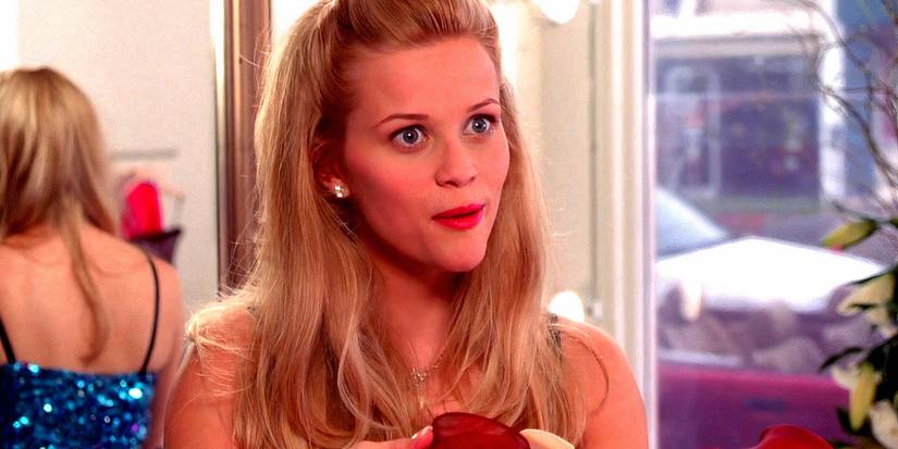 Reese Witherspoon as Elle Woods looking excited in a store in Legally Blonde