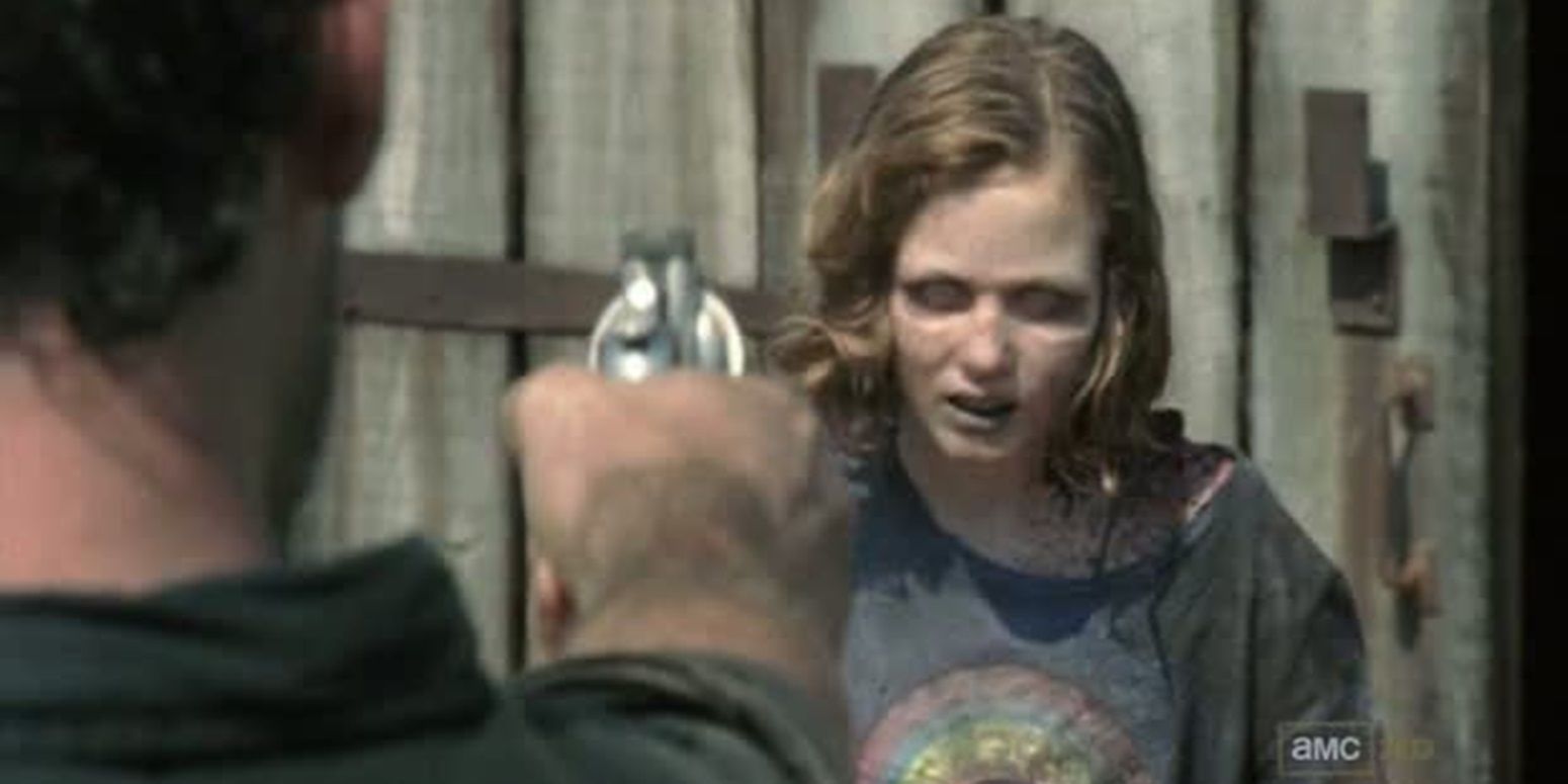 Rick points a gun at undead Sophia in The Walking Dead