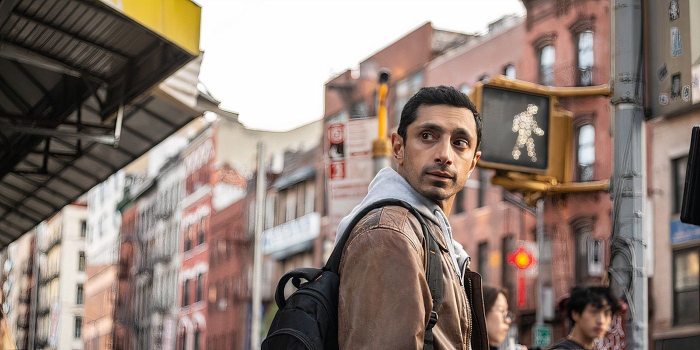 Riz Ahmed turns to look behind him in Relay still