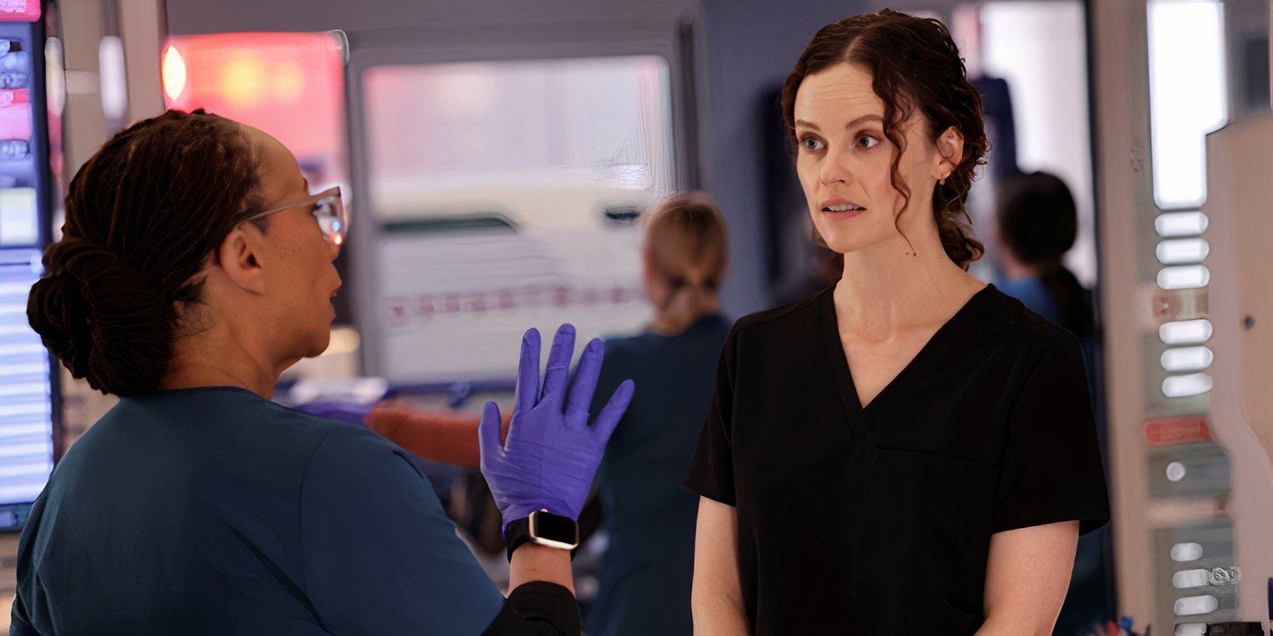 Chicago Med Goodwin holds up her hand while talking to Lenox