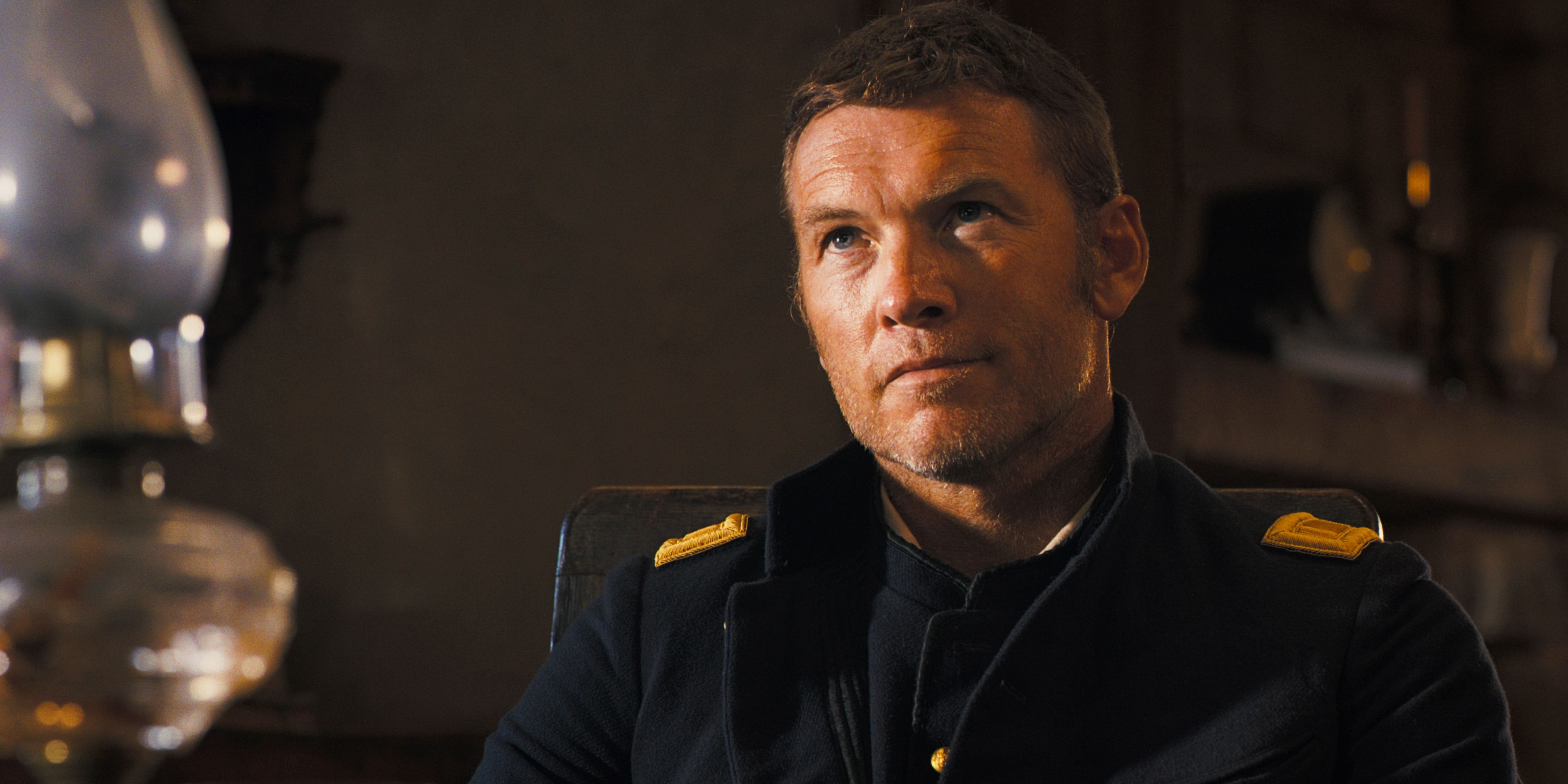 Sam Worthington looks up skeptically in Horizon Chapter 2