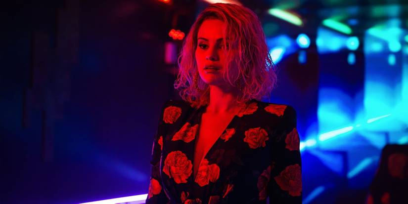 Selena Gomez bathed in red light inside a nightclub in Emilia Perez