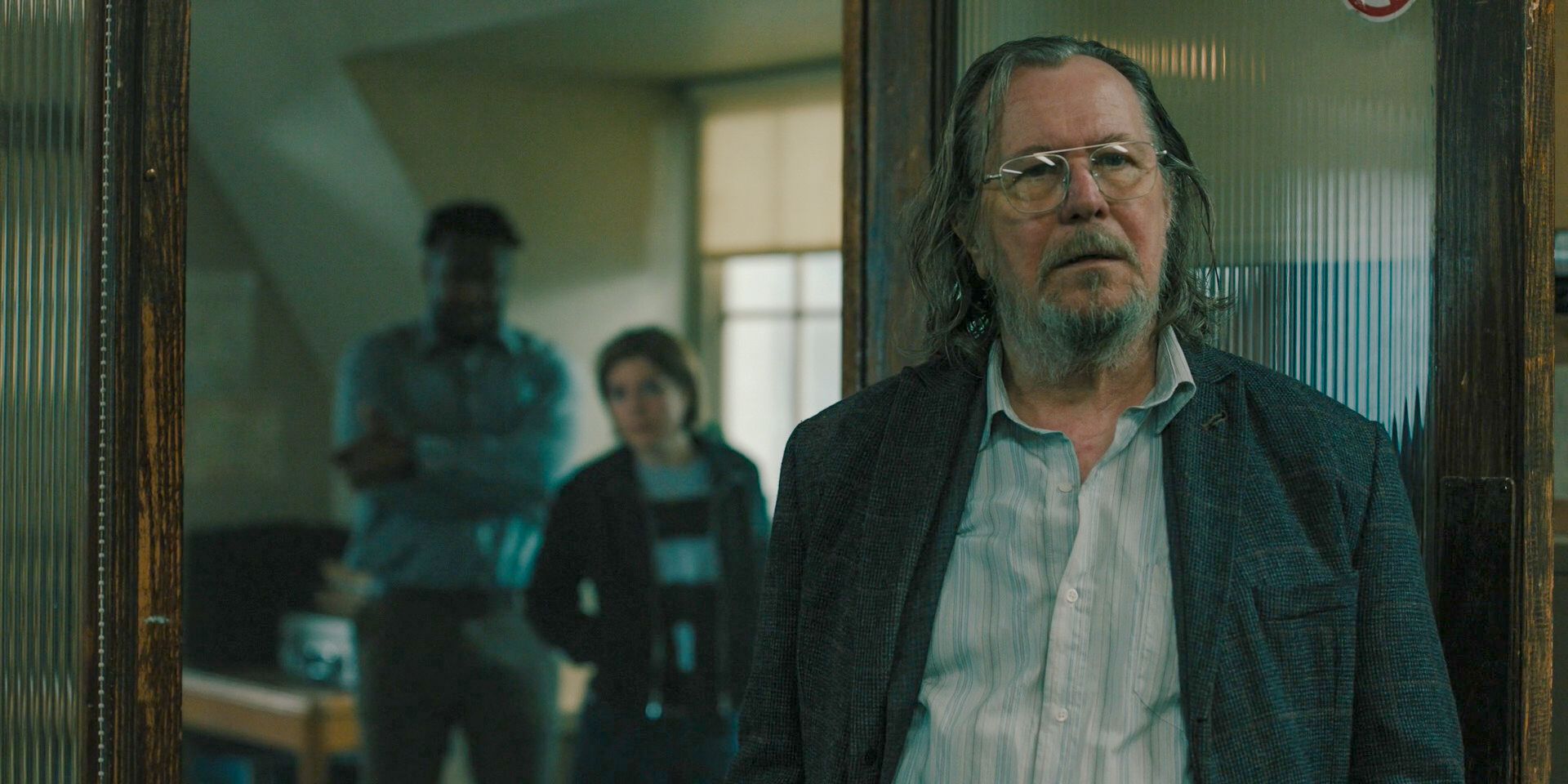 Gary Oldman standing in Slough House as Jackson Lamb in Slow Horses season 4