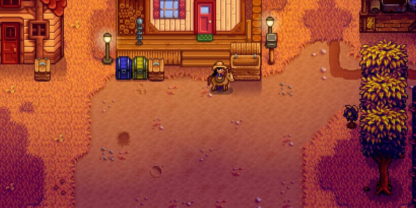 A Stardew Valley farmer stands next to her horse near her home