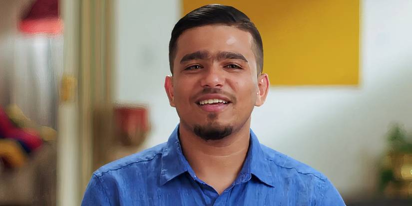Sunny Mahdi in 90 Day Fiance in blue shirt smiling during interview