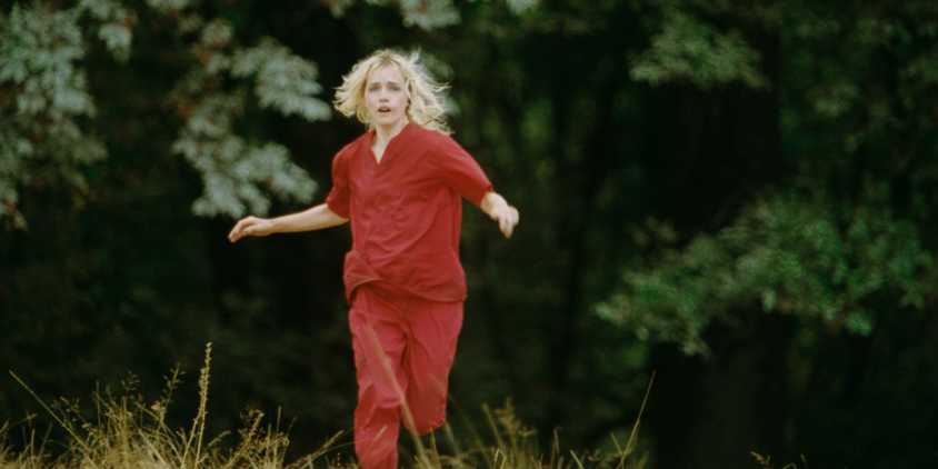 Willa Fitzgerald as The Lady running through the woods in Strange Darling