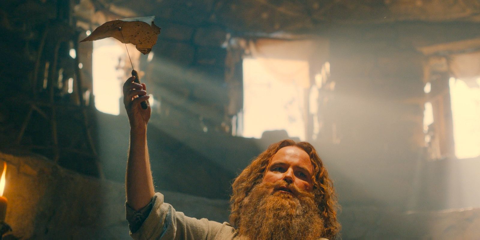 Tom Bombadil (Rory Kinnear) finds the Stranger's star map in The Lord of the Rings: The Rings of Power Season 2 Episode 4