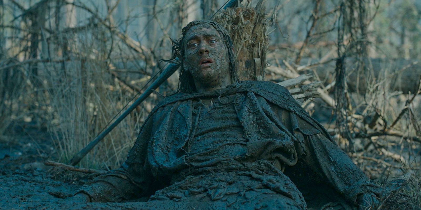 Isildur (Maxim Baldry) covered in mud after being swallowed by the swamp monster in The Lord of the Rings: The Rings of Power Season 2 Episode 4