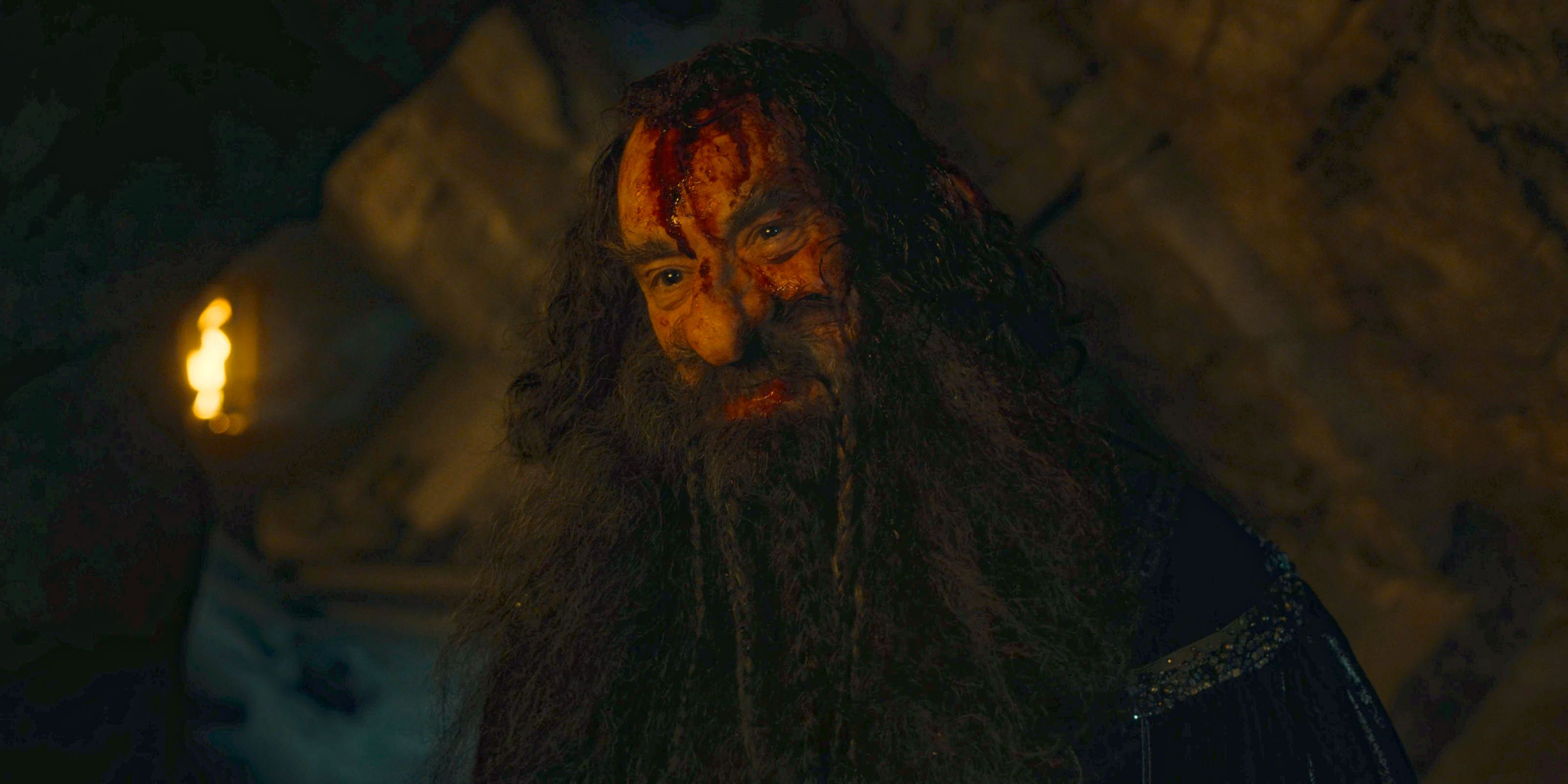 Narvi (Kevin Eldon) wounded by King Durin's axe in The Lord of the Rings: The Rings of Power Season 2 Episode 7