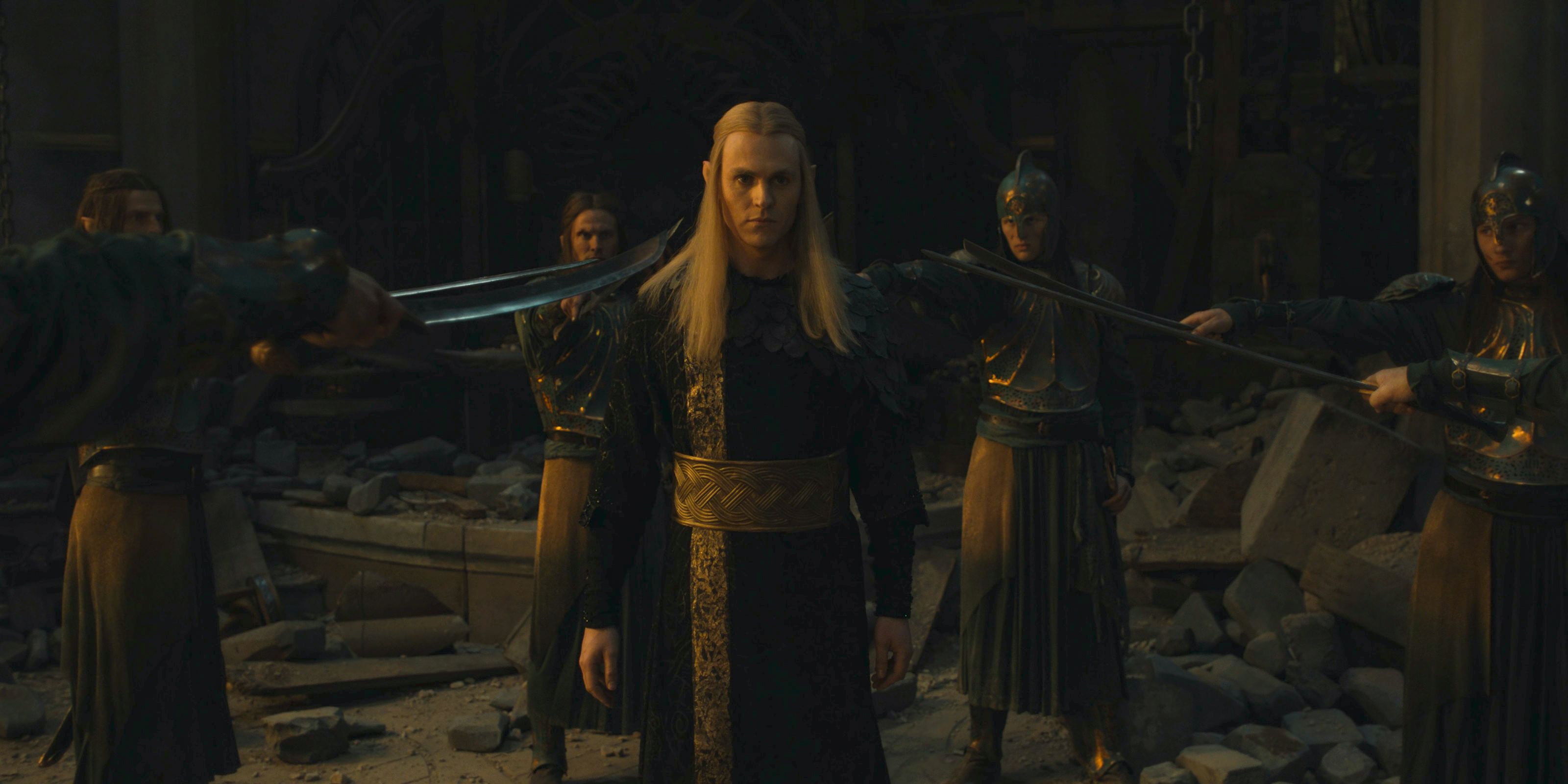 Sauron (Charlie Vickers) being held at swordpoint by the elven guard of Eregion in The Lord of the Rings: The Rings of Power Season 2 Episode 7