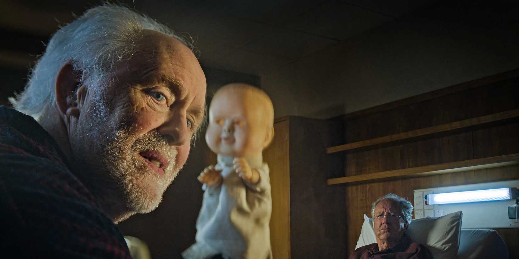 John Lithgow holding a doll in The Rule of Jenny Pen