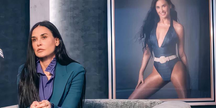 The Substance Demi Moore with a poster of herself behind her