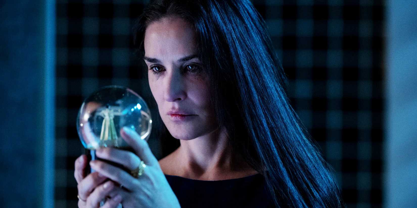 Elisabeth Sparkle holding a snowball in The Substance