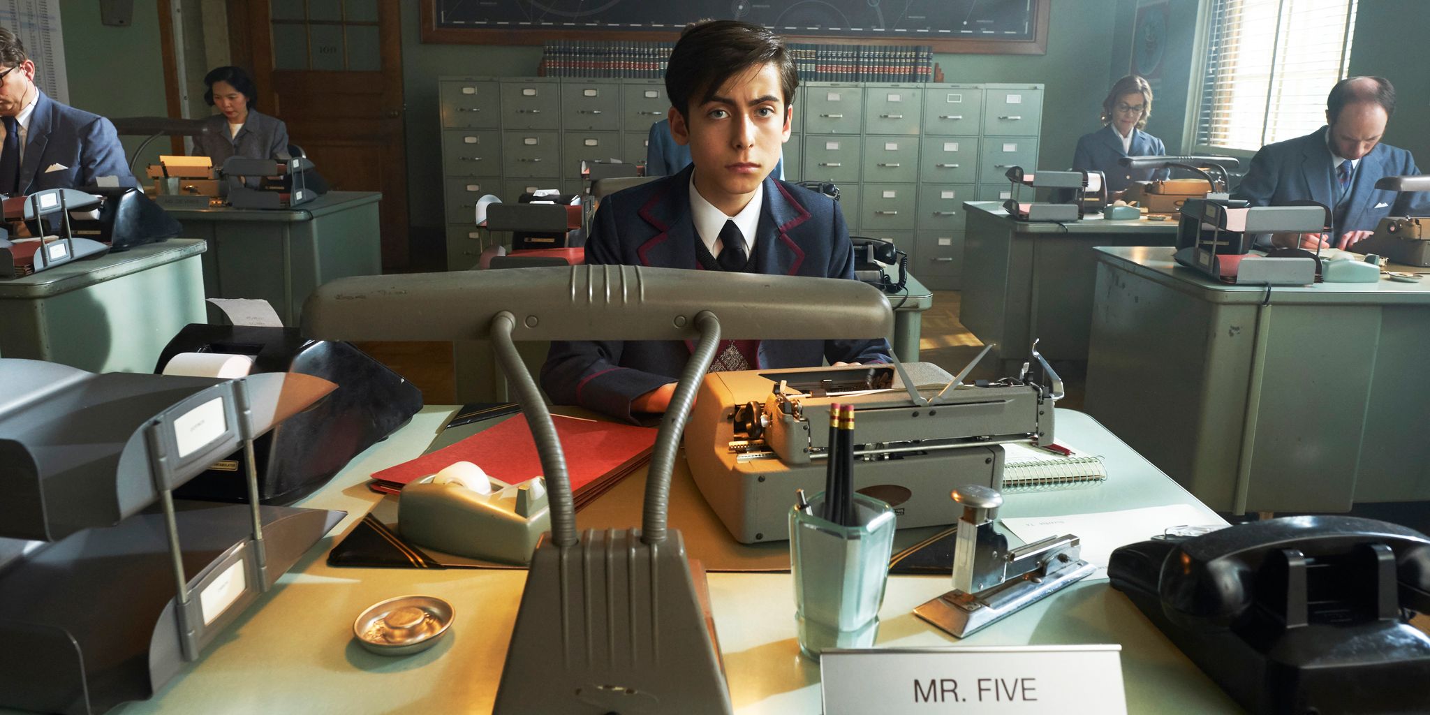 Young Five at his desk in The Commission in The Umbrella Academy.