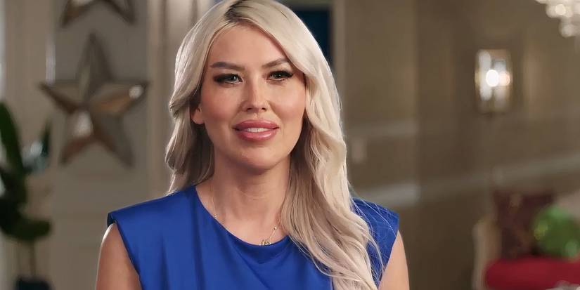 Tigerlily Taylor in 90 Day Fiance Before the 90 days in blue dress and platinum blonde hair smiling