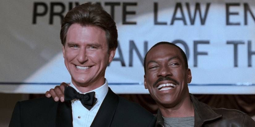 Timothy Carhart as DeWald and Eddie Murphy as Axel fake smiling in Beverly Hills Cop 3