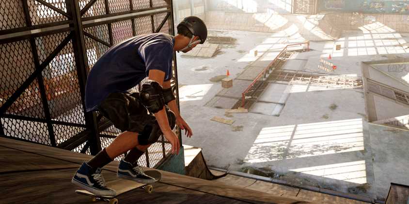 A skater descending a ramp into a warehouse in Tony Hawk's Pro Skater 1 + 2.