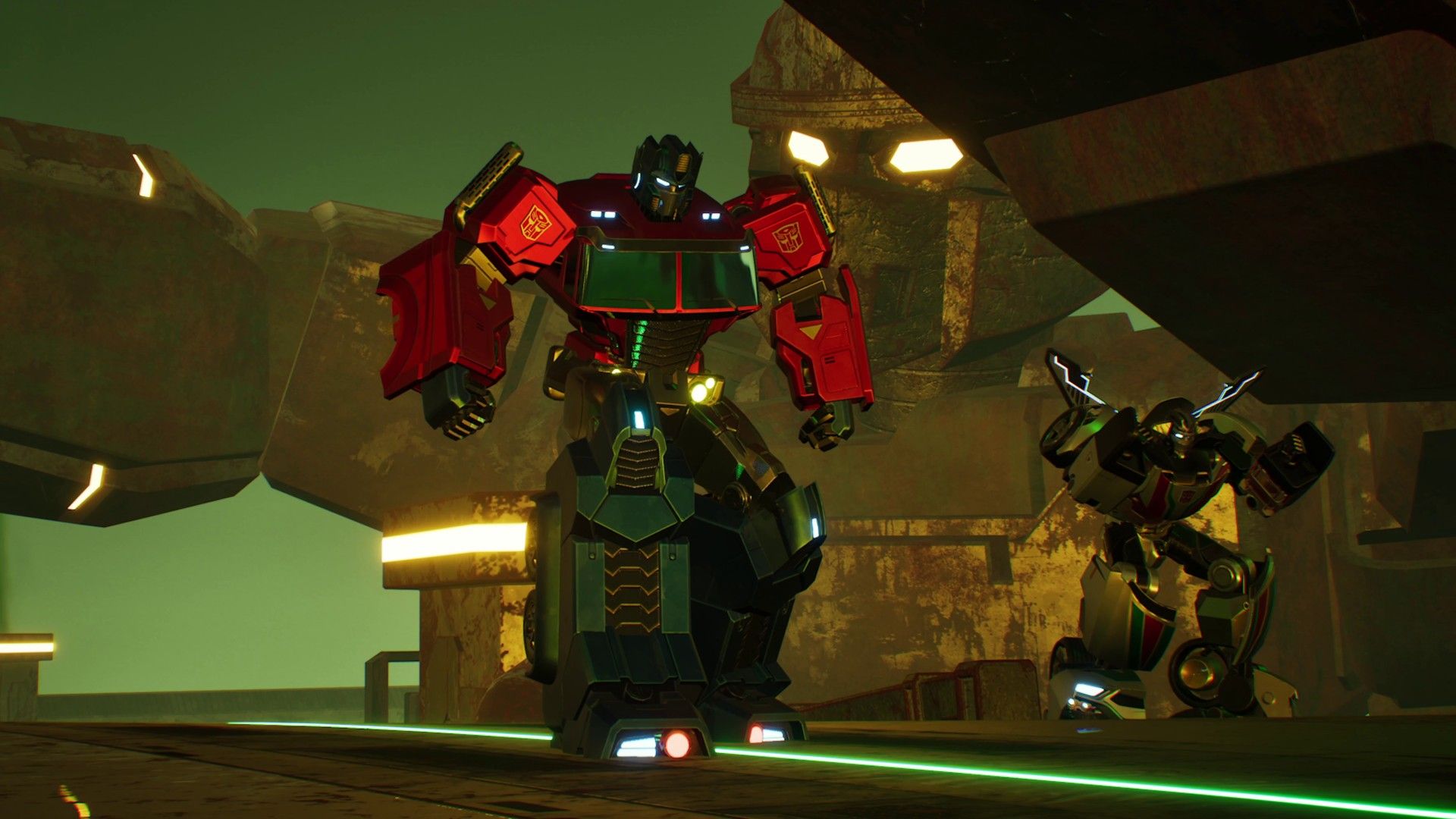 Transformers Galactic Trials Optimus Prime and Bumblebee standing next to one another, a stone Transformer structure is behind them.