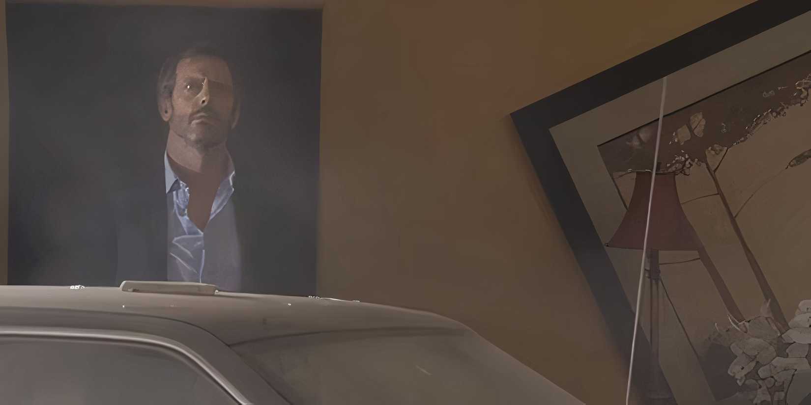 Hugh Laurie as Gregory House stood in the wreckage of Cuddy's dining room after crashing in the House episode "Moving On."
