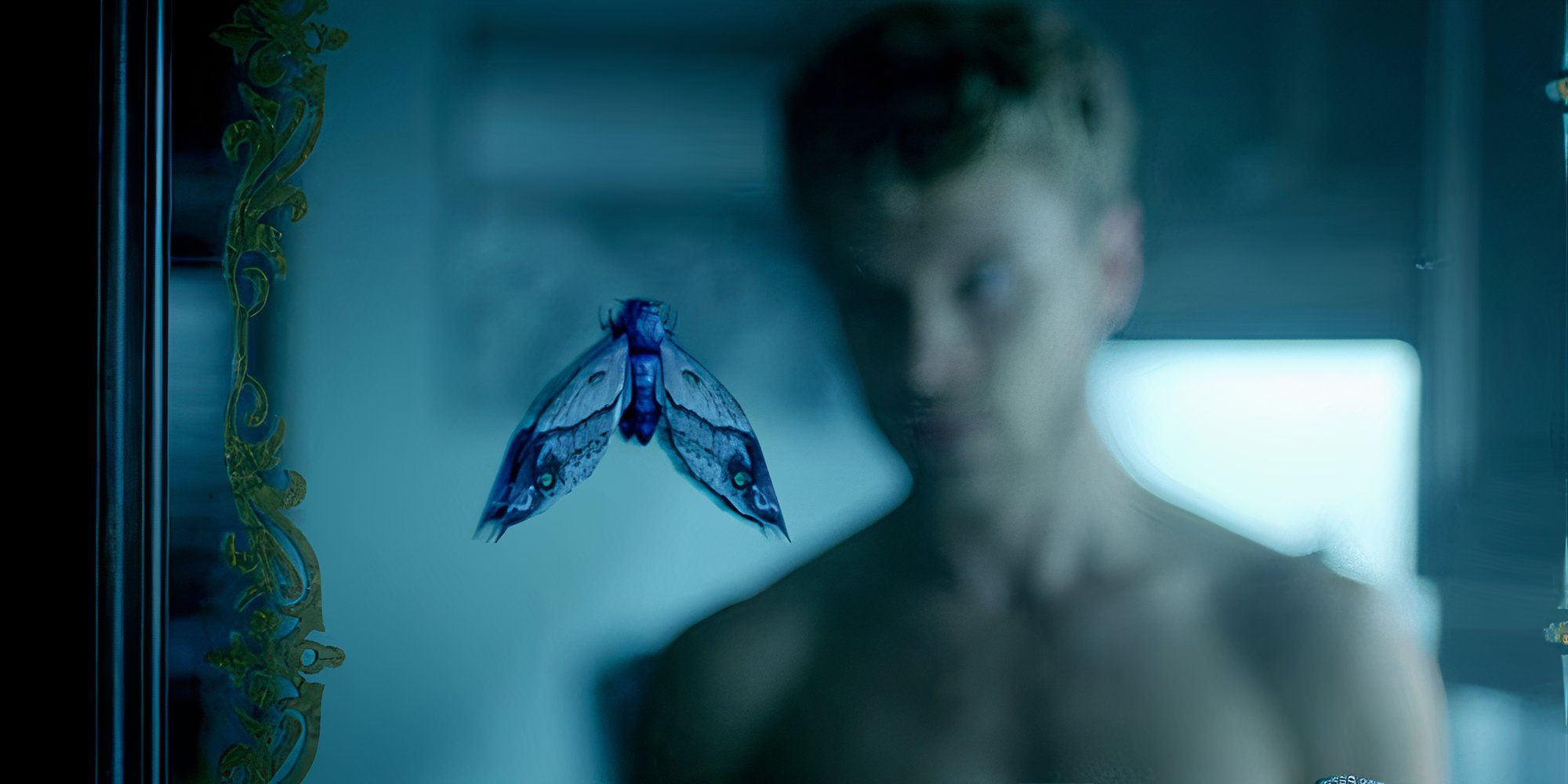 Mike McCormick looking at a moth on his bathroom mirror in The Magicians.