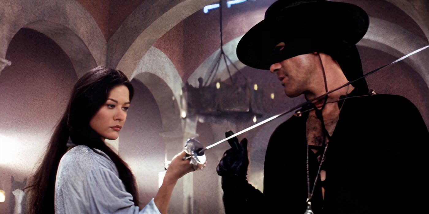 Catherine Zeta-Jones as Elena holding a fencing sword up to the throat of Antonio Banderas as Zorro in The Mask Of Zorro.