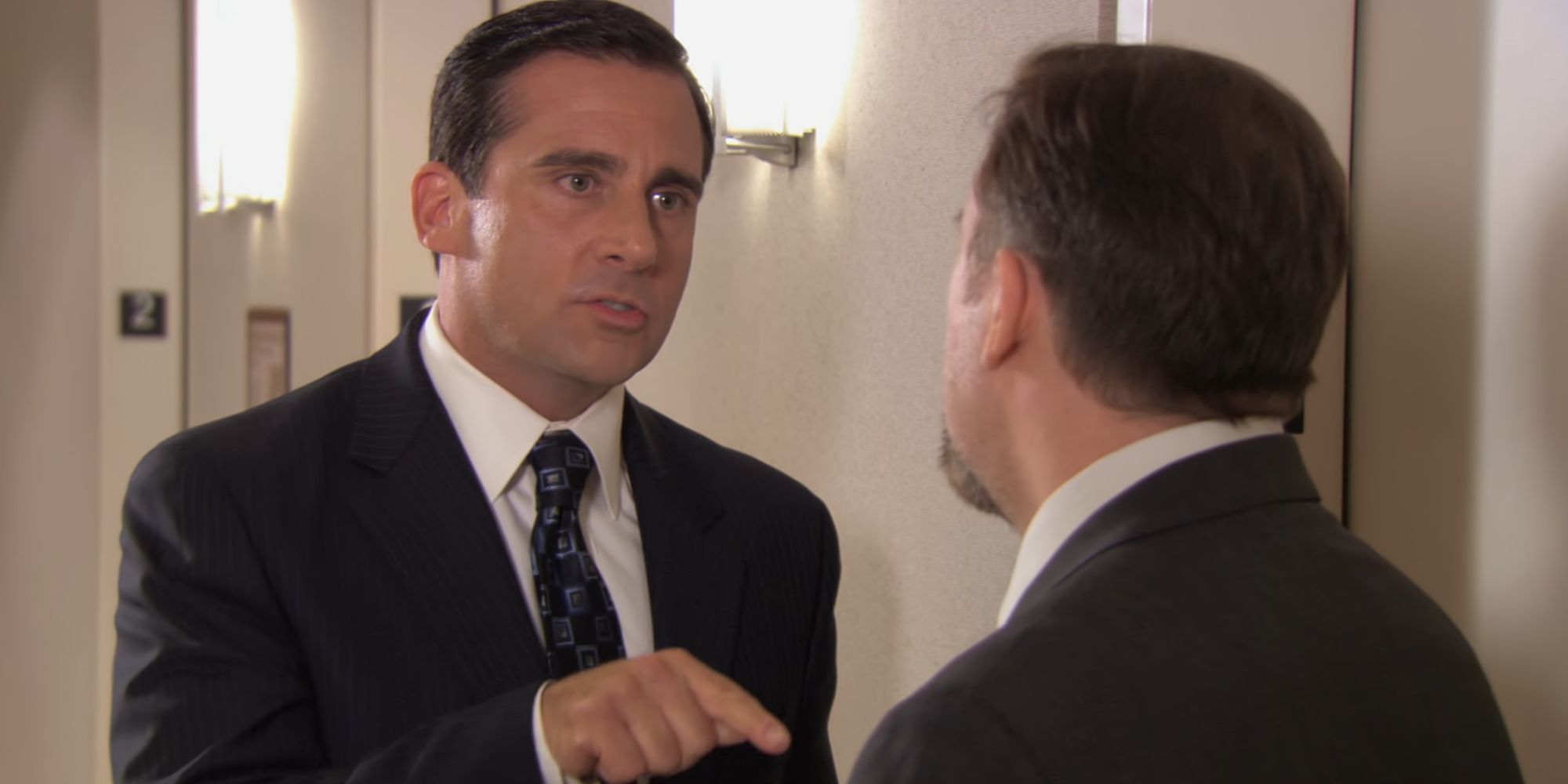 Steve Carell as Michael Scott talking to Ricky Gervais as David Brent in The Office