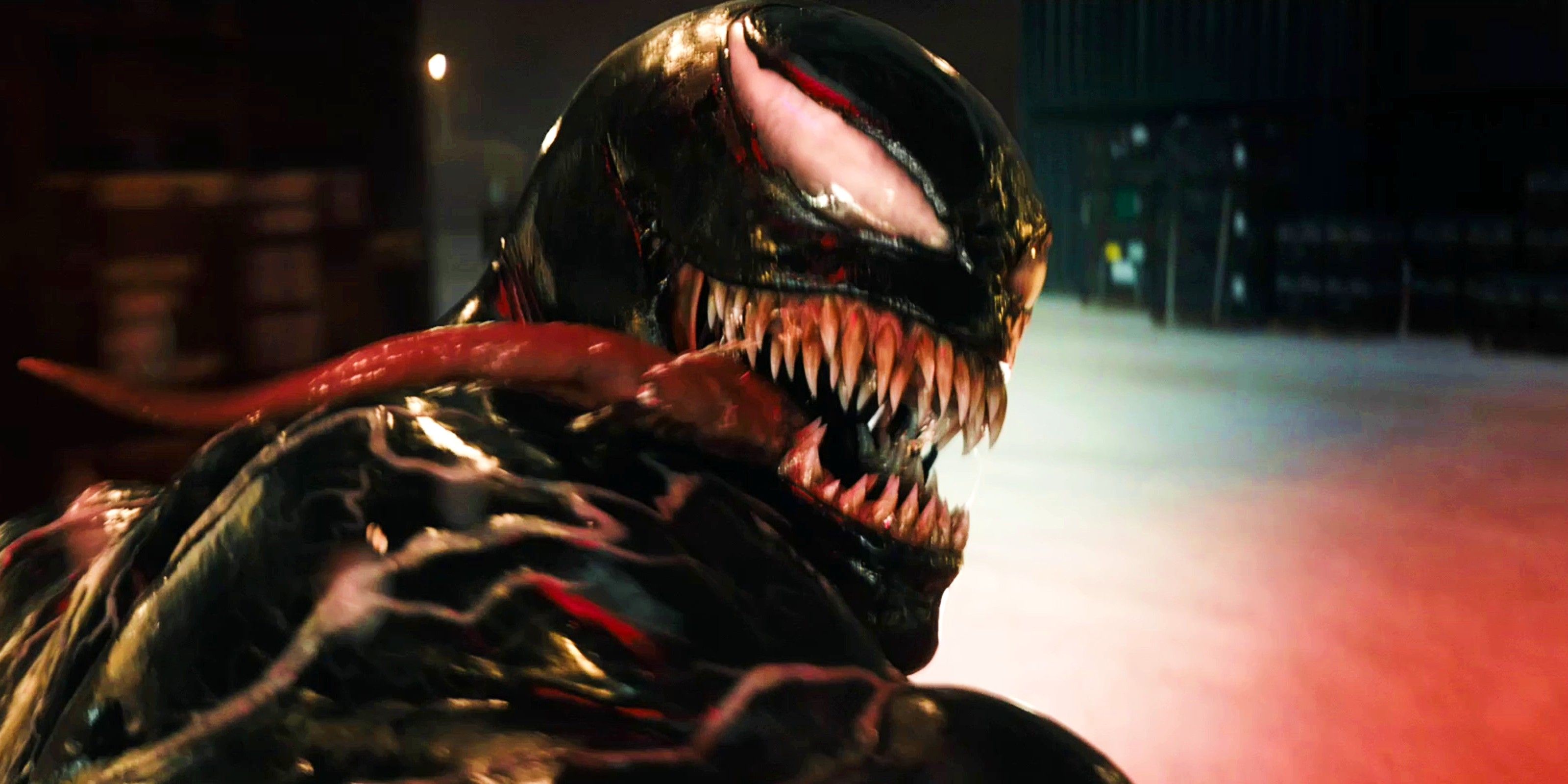 Venom looks over his shoulder with his tongue out in the trailer for Venom The Last Dance