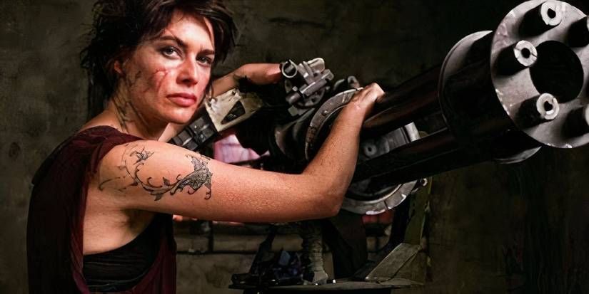 Lena Headey as Ma Ma in Dredd (2012) leaning on a gun