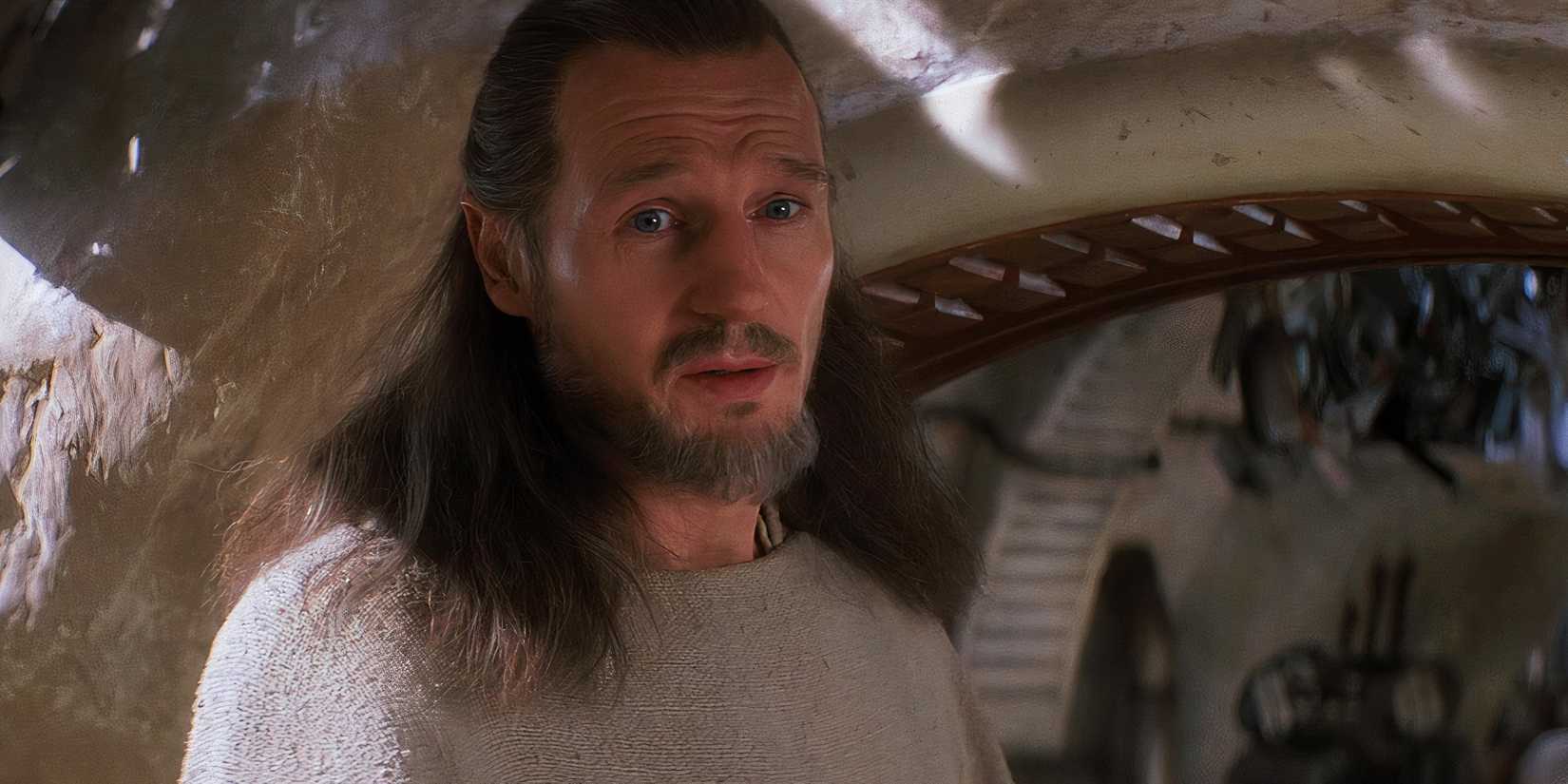Qui-Gon Jinn (Liam Neeson) looks back and speaks to Padmé Amidala on Tatooine.