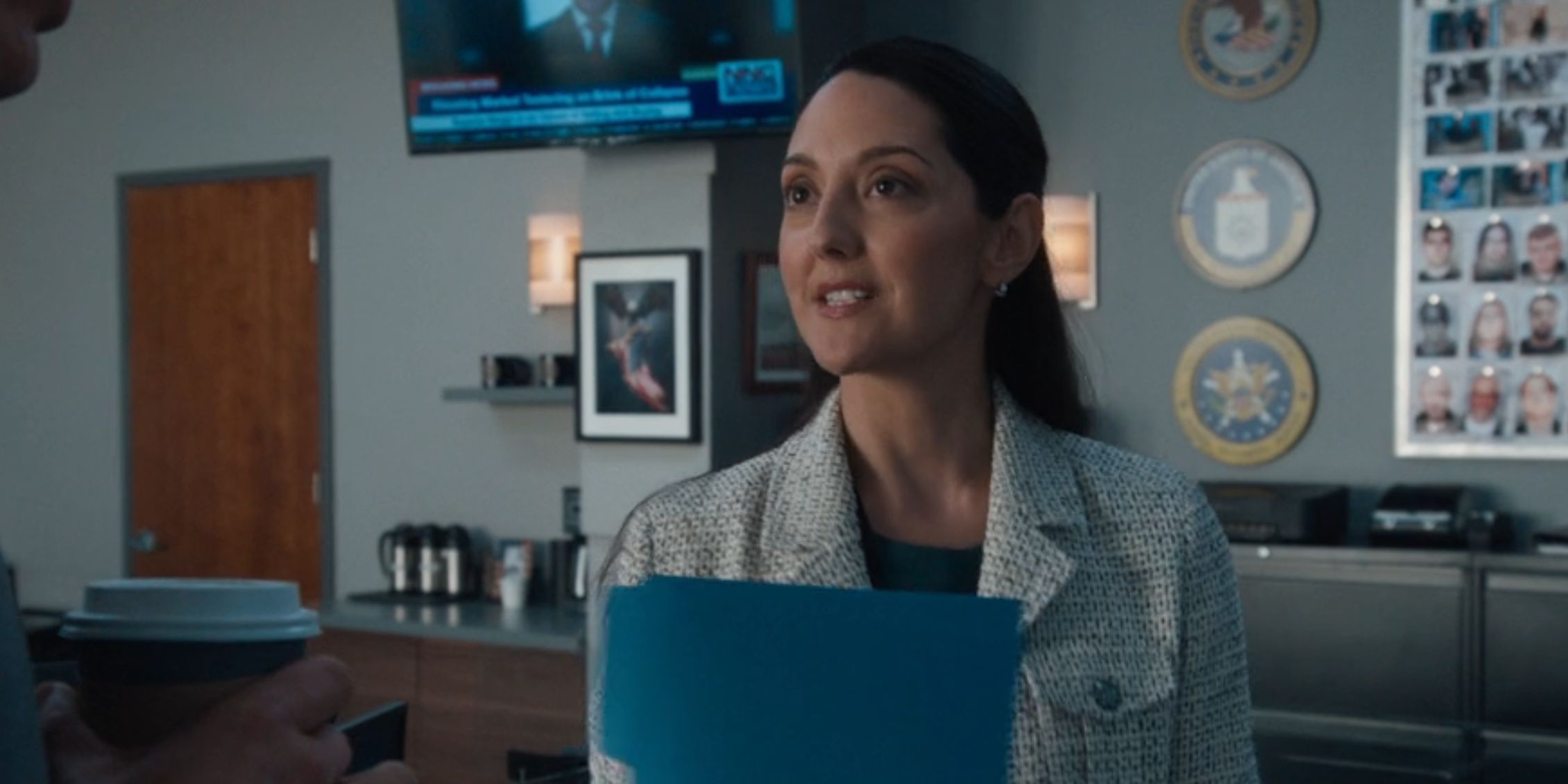 FBI Sofia holding a blue folder as she introduces herself