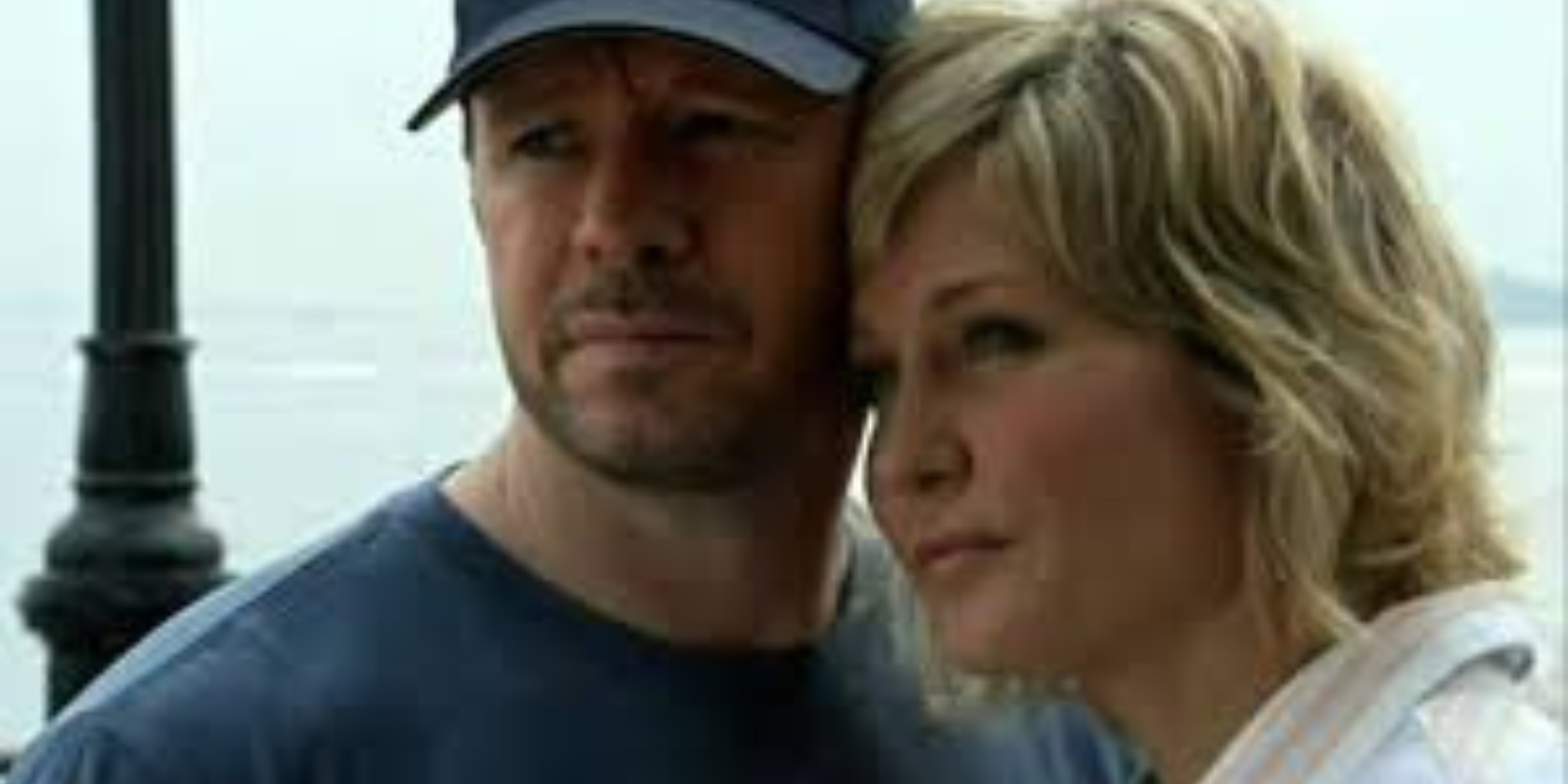 Blue Bloods Linda leaning her head against Danny who is wearing a baseball cap