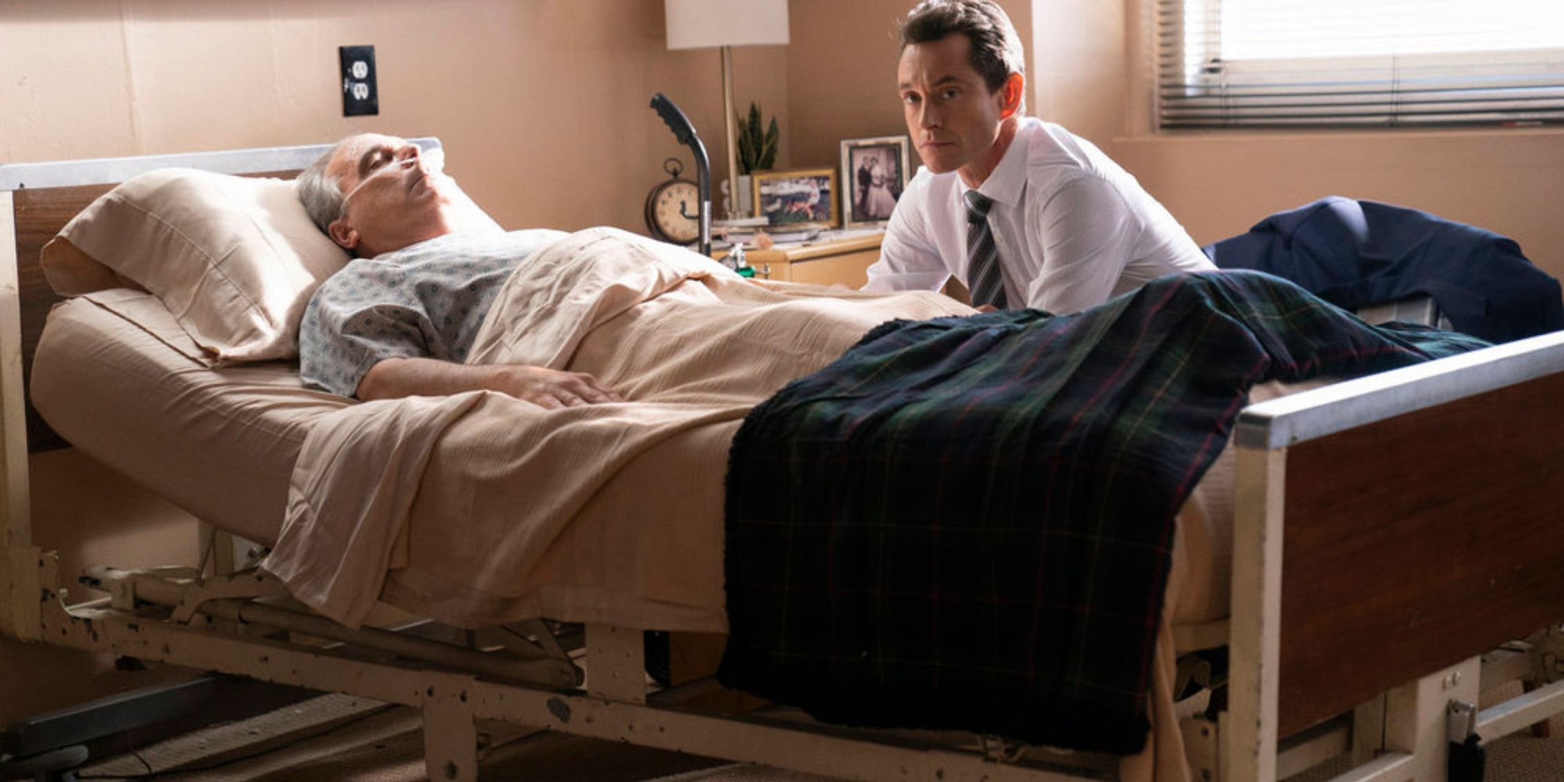 Law & Order Nolan sitting with his comatose father in a room