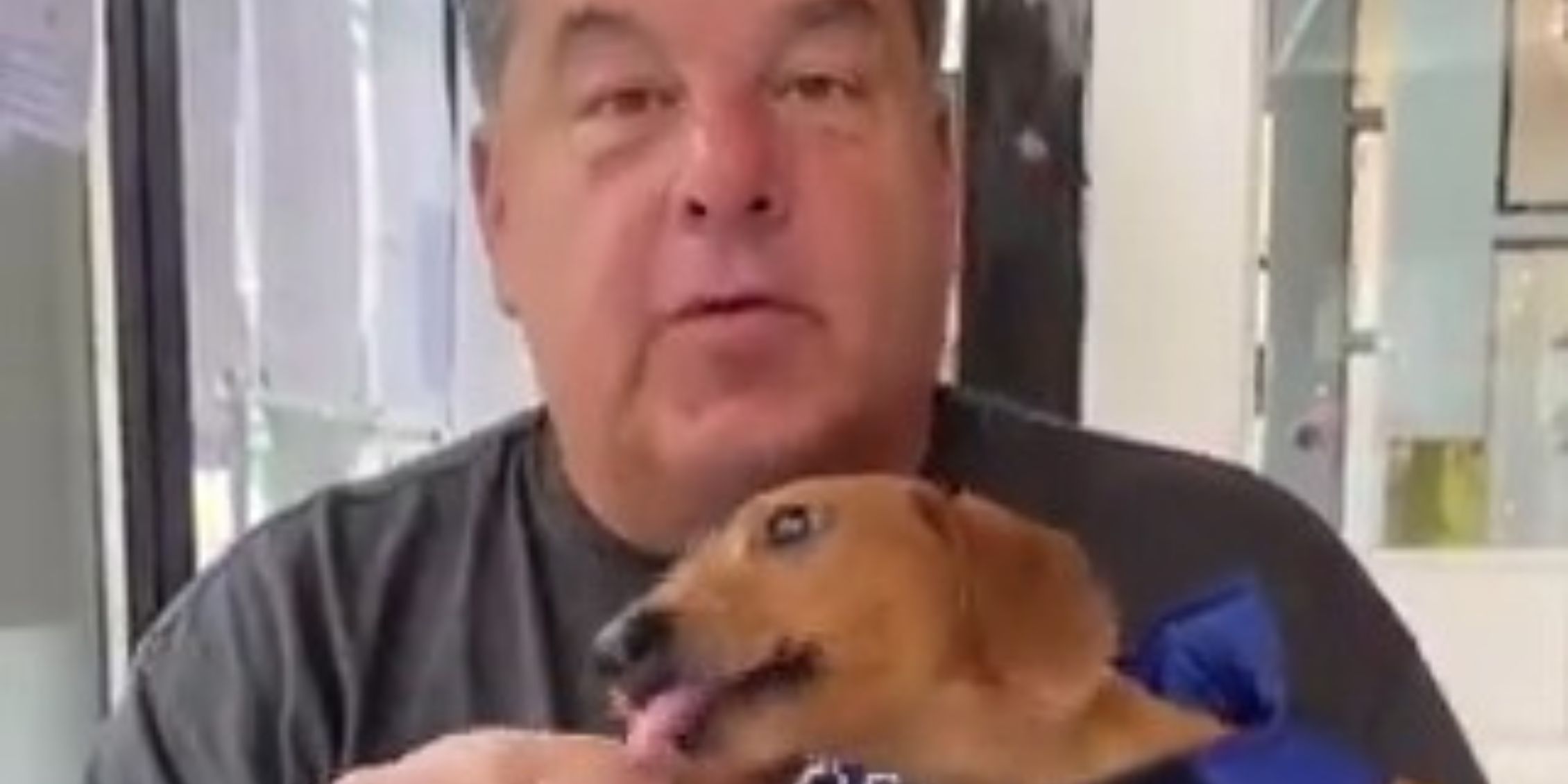 Blue Bloods actor Steve Schirripa holding WIllie Boy who is licking food out of his hand