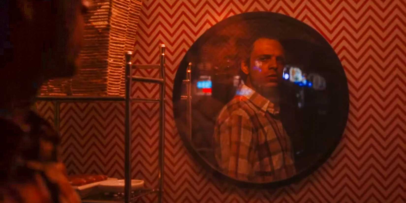 Edward (Sebastian Stan) looking at his new reflection in the mirror in A Different Man