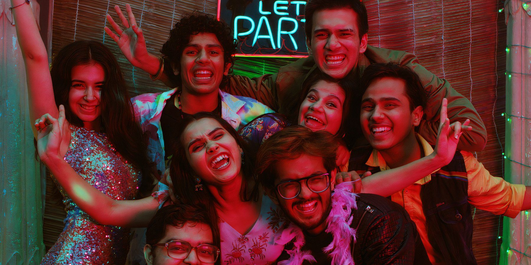 A group of students in front of a neon party sign in the Hindi series Crash Course