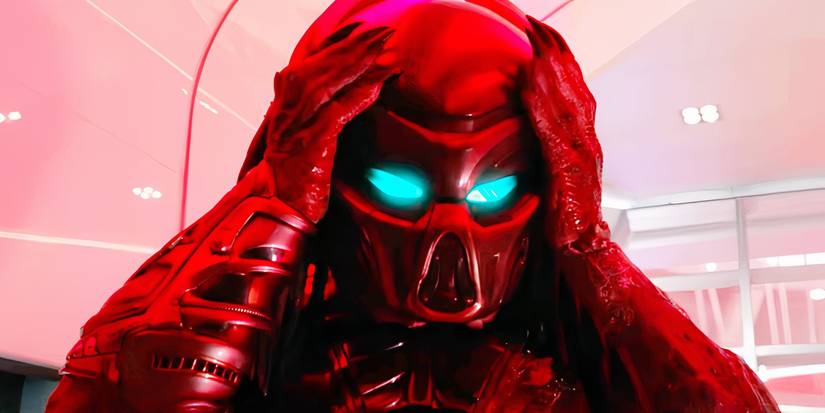 A Yautja puts on his helmet with glowing eyes in The Predator