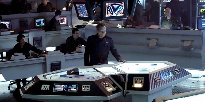 Adama standing in the CIC in Battlestar Galactica.