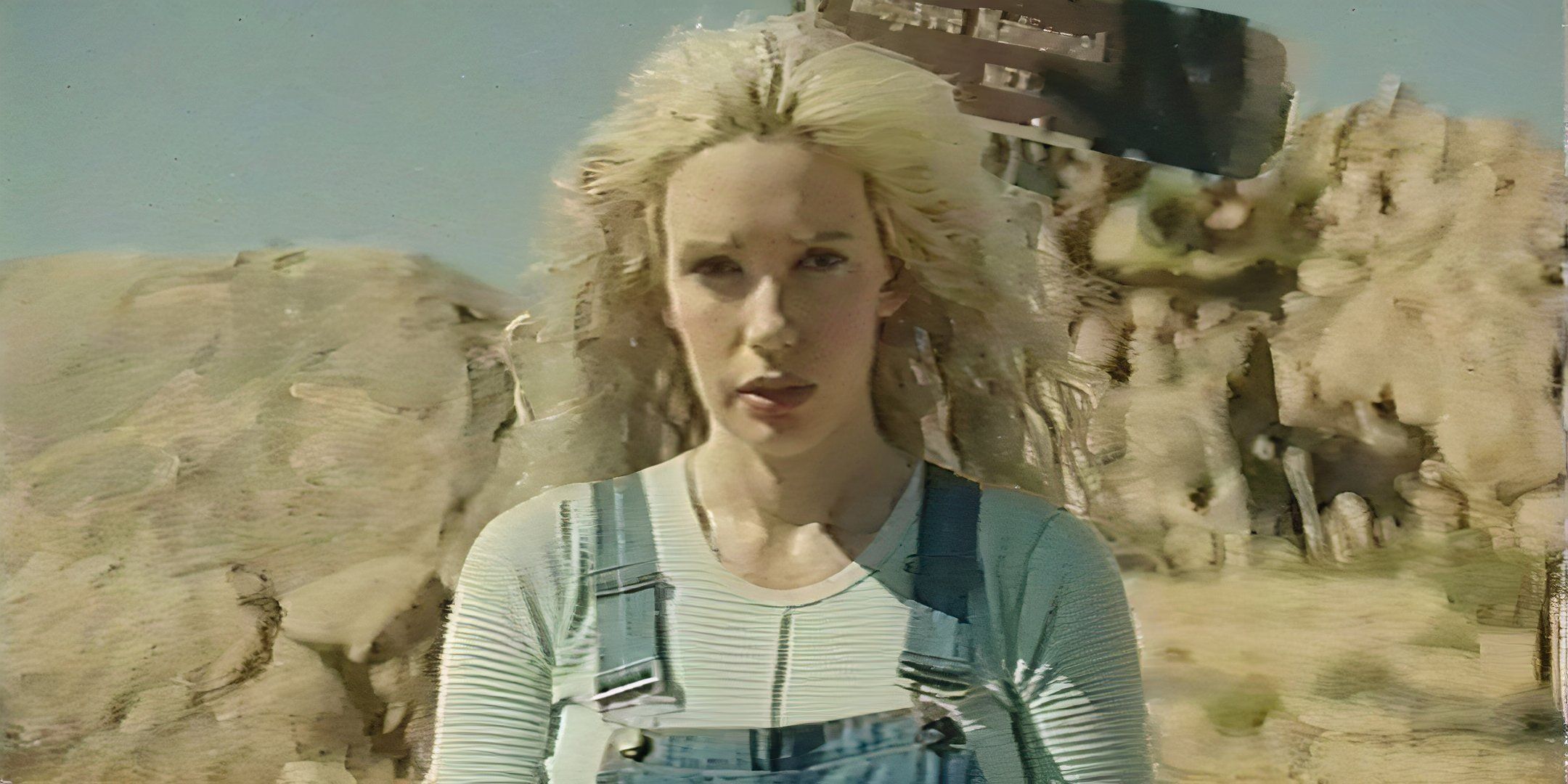 Alanah Pearce as Halley talking to the camera in front of a Mojave Desert sign in V/H/S/Beyond