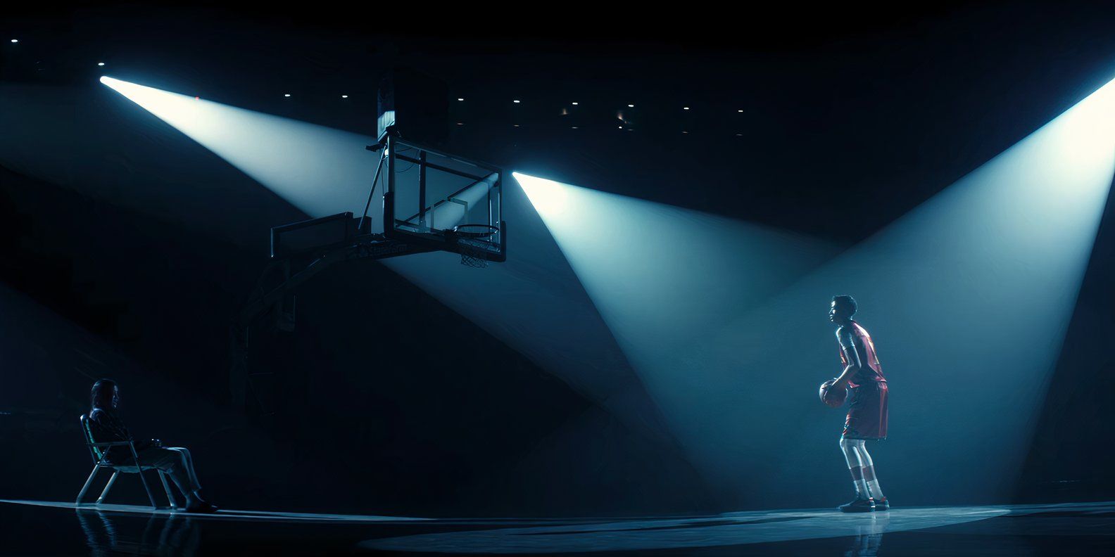 Jimmy Holiday (Kauchani Bratt) preparing for a free throw under three spotlights at the end of Rez Ball