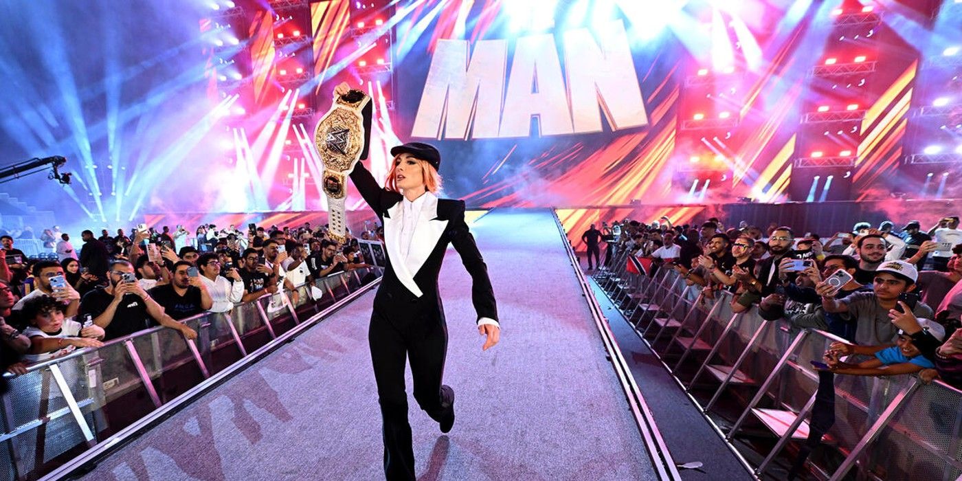 Becky Lynch walks down the ramp holding the WWE World Women&rsquo;s Championship at King and Queen of the Ring