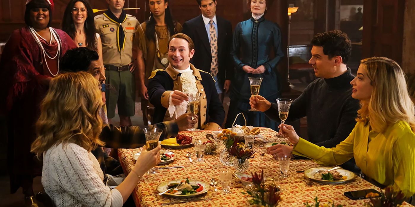 Brandon Scott Jones as Isaac Higgintoot in CBS Ghosts sitting with Same and Jay at the table