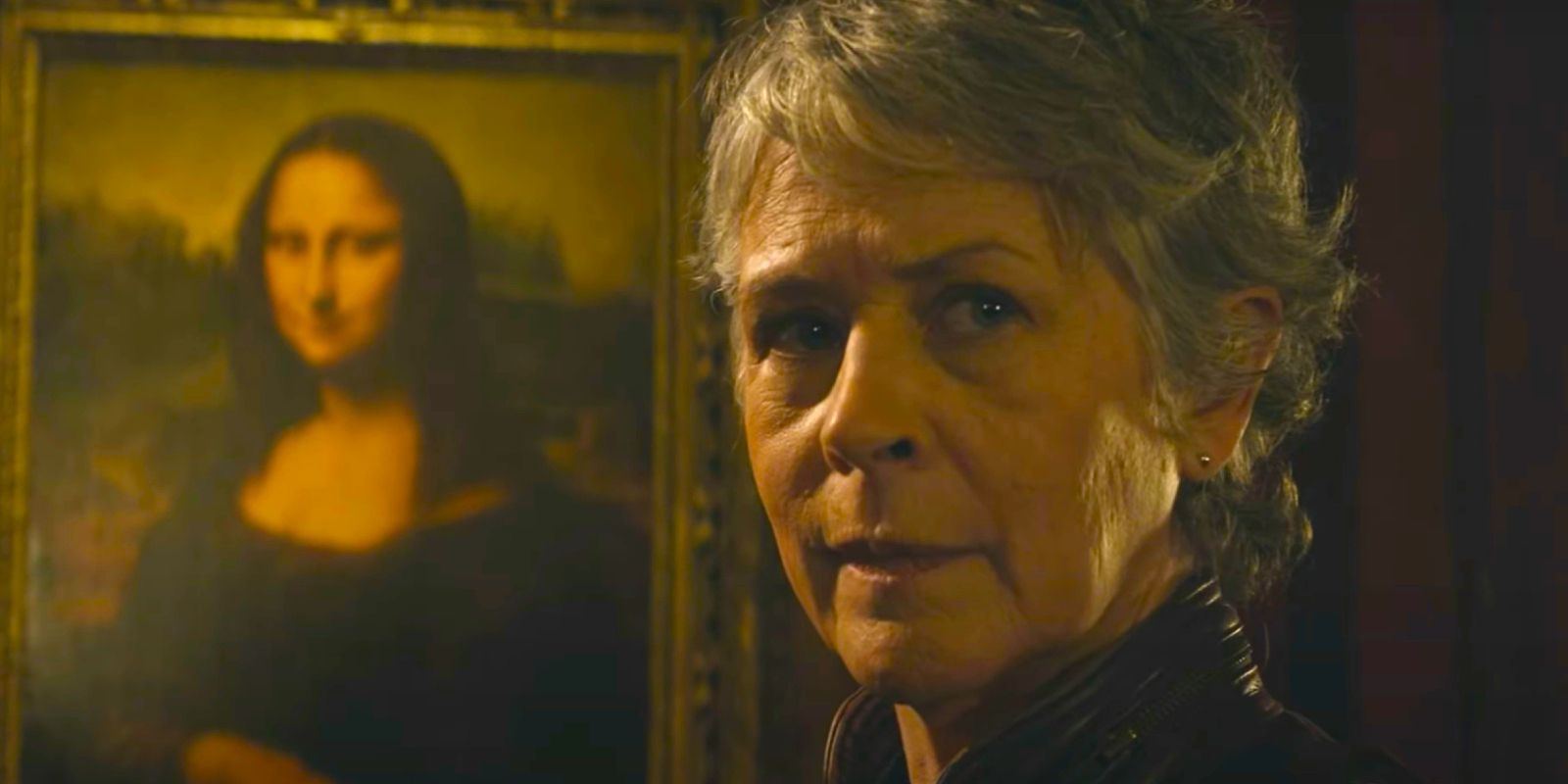 Carol looking suspicious while next to the Mona Lisa in The Walking Dead Daryl Dixon season 2 episode 3