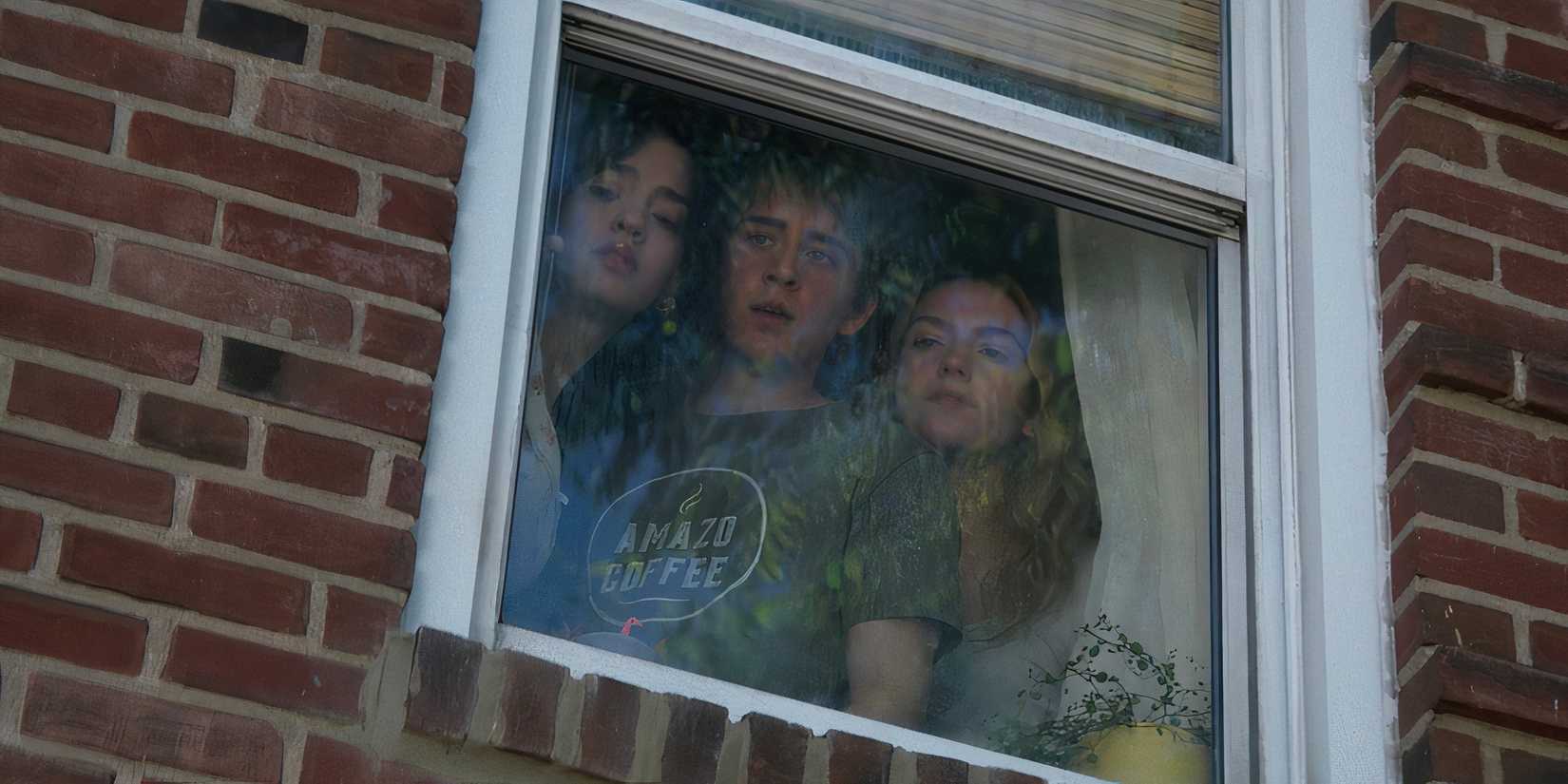 Cece, Devin and Frankie looking suspiciously out of a bedroom window in Goosebumps The Vanishing