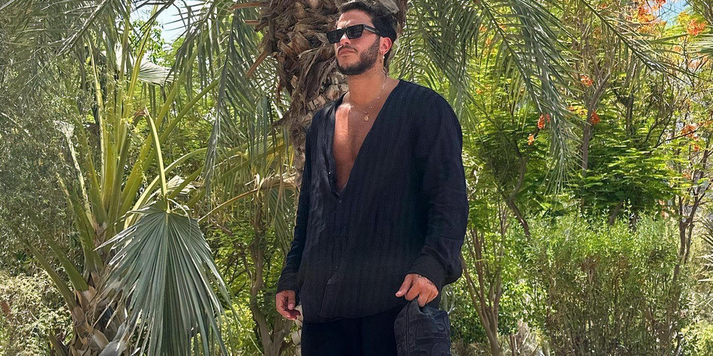 Love Is Blind Habibi season 1 Chafic Yactine in an all-black outfit with green vegetation in the background 