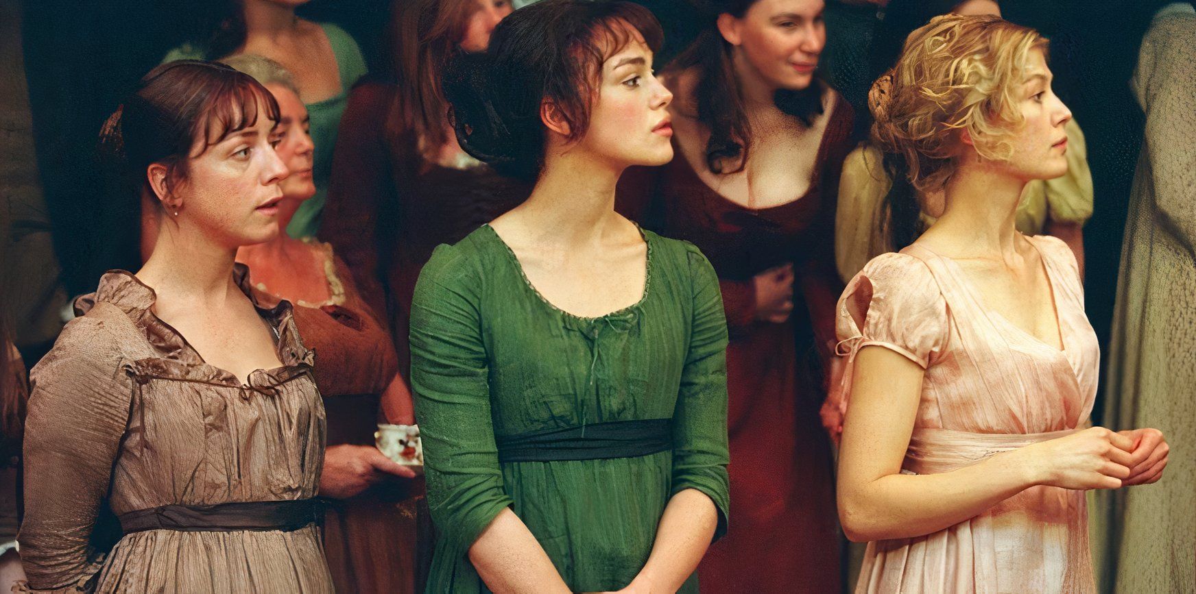 Charlotte alongside Elizabeth and Jane in a crowd at a ball in Pride and Prejudice 2005