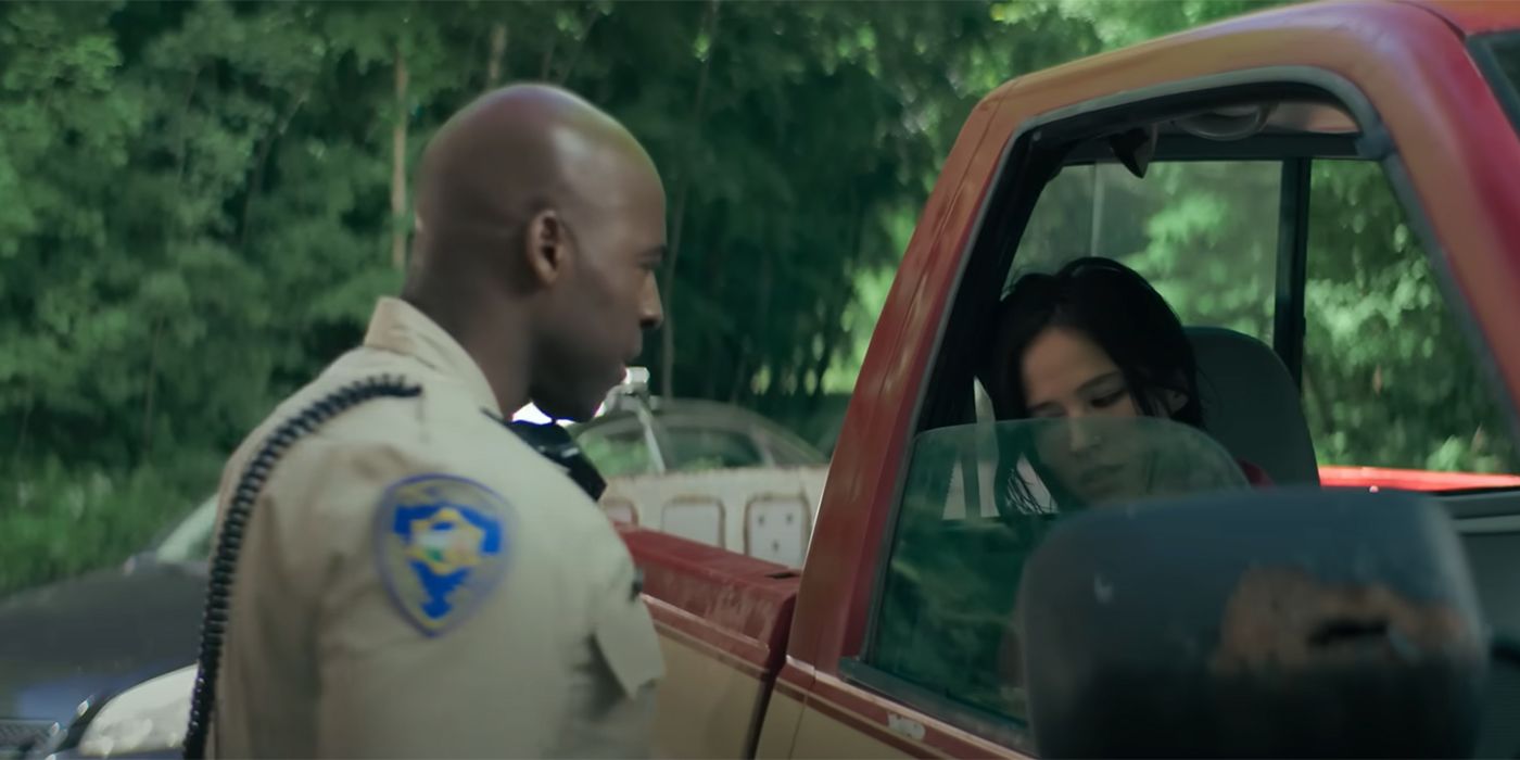 Cop walking over to check on Kelsey Asbille's car in Don't Move