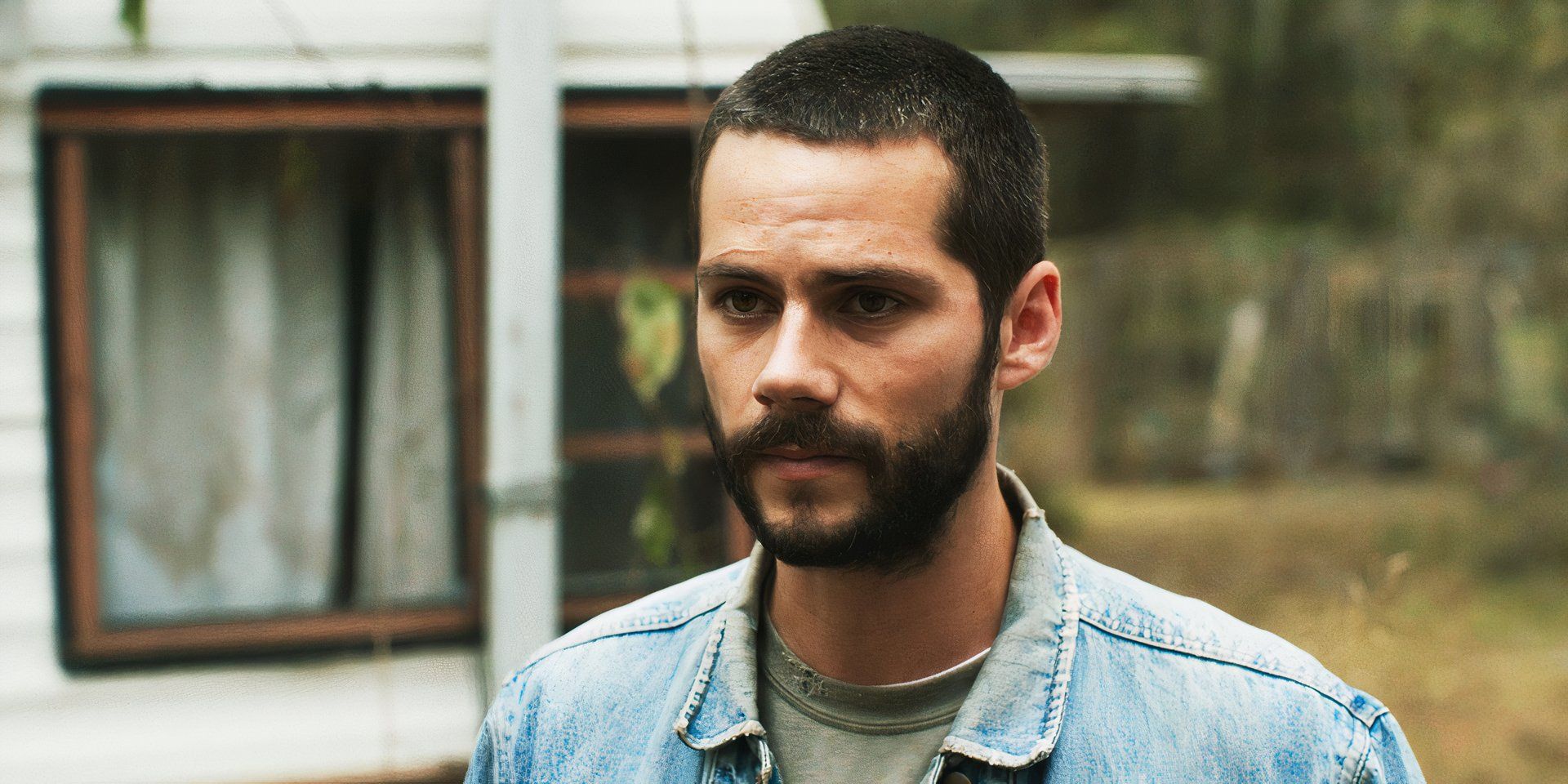 Dylan O'Brien staring at someone, as Paris, in Caddo Lake