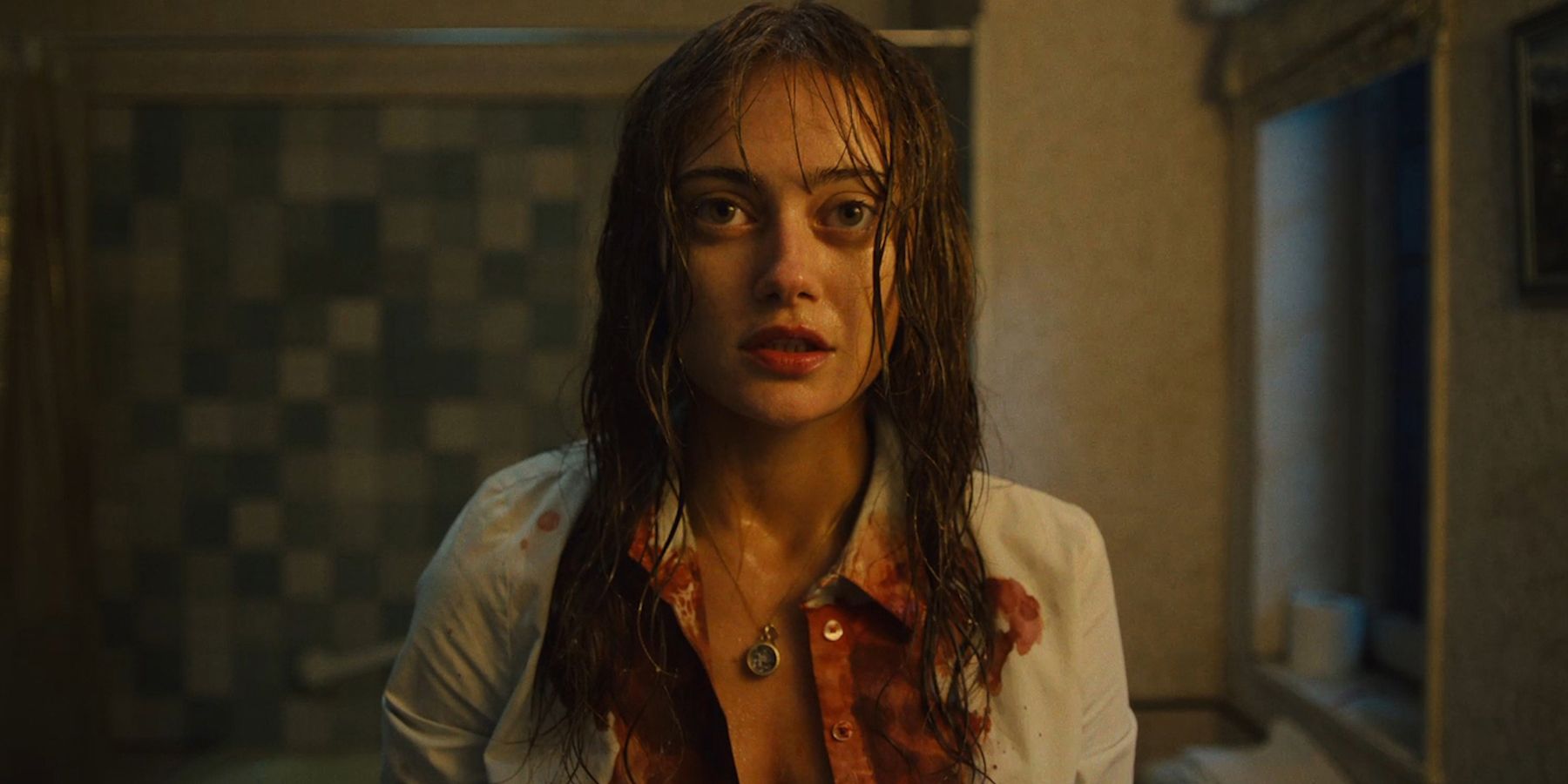 Ella Purnell as Rhiannon staring at the audience with blood on her shirt in Sweetpea 101